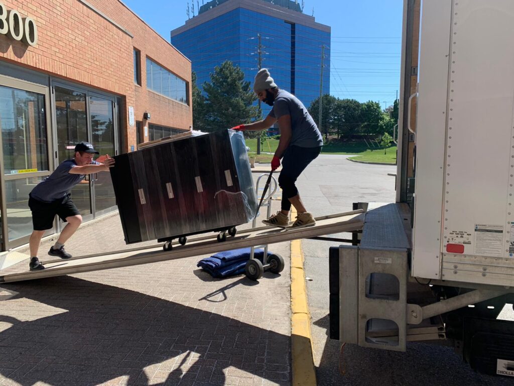 Local movers in Etobicoke loading furniture safely into moving truck