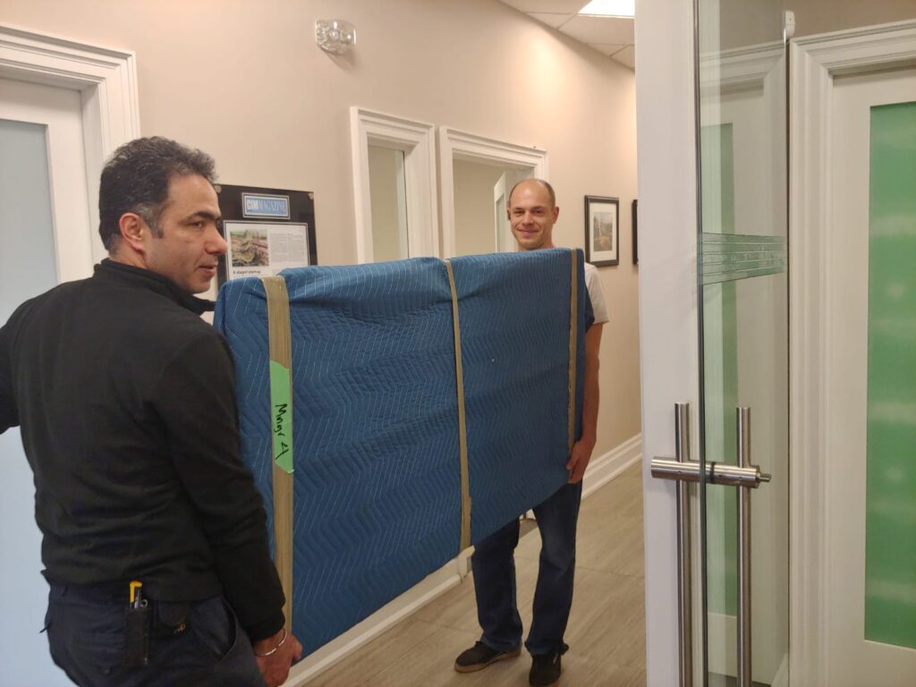 Office movers Etobicoke carrying office furniture during relocation
